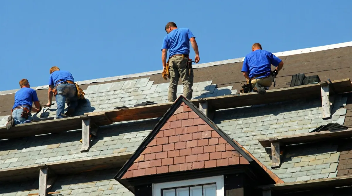 Roof replacement in progress with a team of professional contractors installing new shingles on a residential home in Eugene, OR